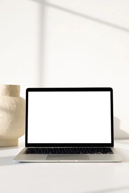 Side view of a stylish woman with afro hair using a touchscreen indoors.